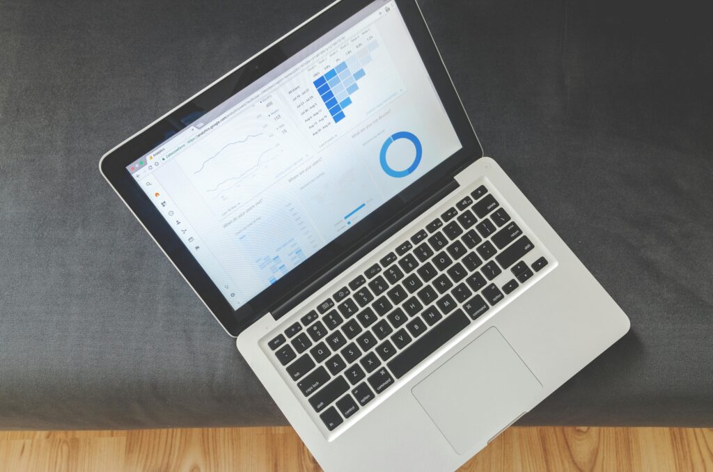 pexels-photo-577195-577195 Overhead view of a laptop showing data visualizations and charts on its screen.